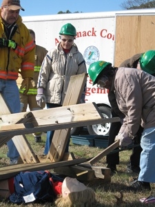 CERT class members practice a rescue operation using cribbing materials